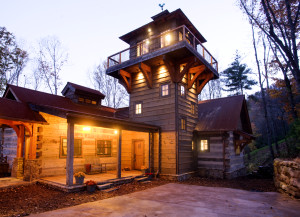 Tower of one of our log cabin plans at dusk
