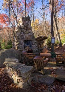 Exterior fireplace near our log cabin design