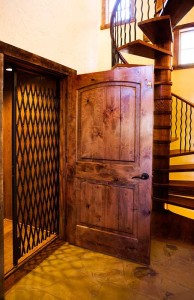 Elevator door detail in tower of one of our log home plans