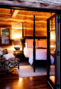 Lit bedroom in one of our log cabin designs